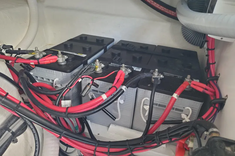 Slide: The Image of Battery compartment of a 2021 Beneteau Flyer 10 with red and black cables. - 26