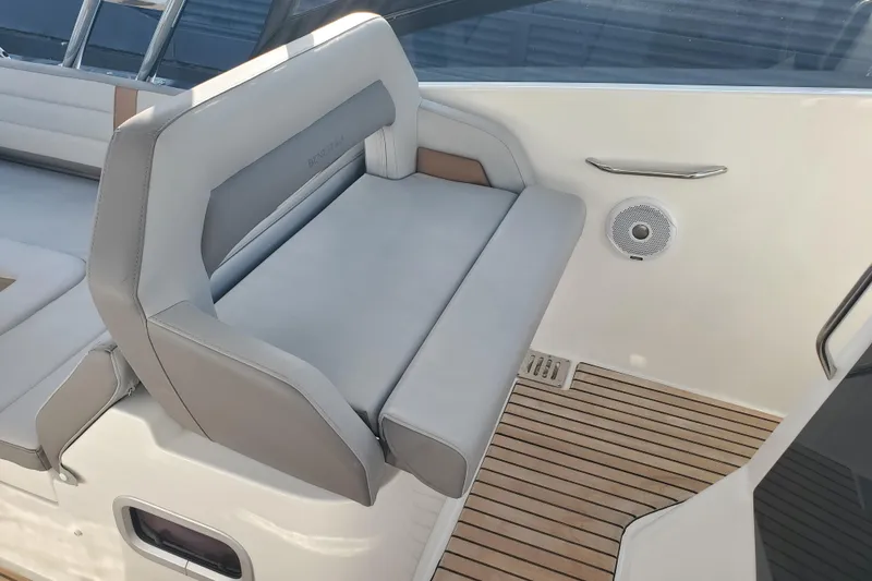 Slide: The Image of 2021 Beneteau Flyer 10 boat interior with cushioned seating and teak flooring. - 8
