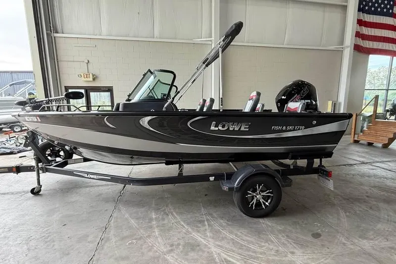 Slide: The Image of 2017 Lowe Fish & Ski 1710 boat on trailer in indoor setting. - 1