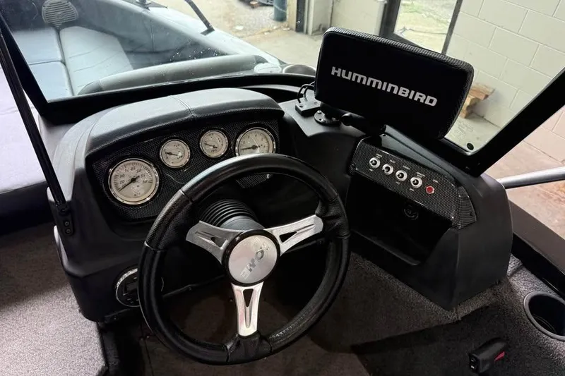 Slide: The Image of 2017 Lowe Fish & Ski 1710 boat dashboard with steering wheel and Humminbird fish finder. - 10