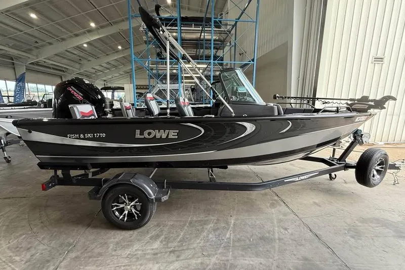 Slide: The Image of 2017 Lowe Fish & Ski 1710 boat on trailer in indoor showroom. - 2