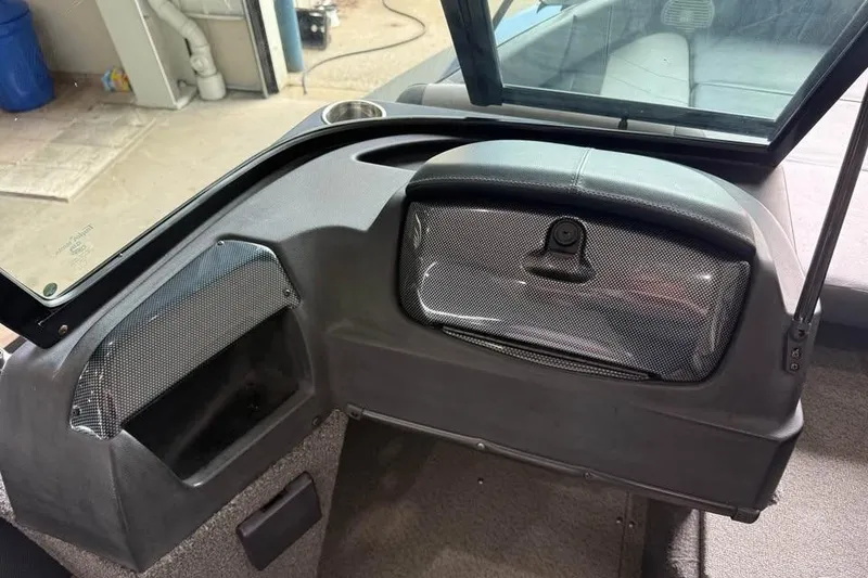 Slide: The Image of 2017 Lowe Fish & Ski 1710 boat interior with storage compartments and windshield. - 9