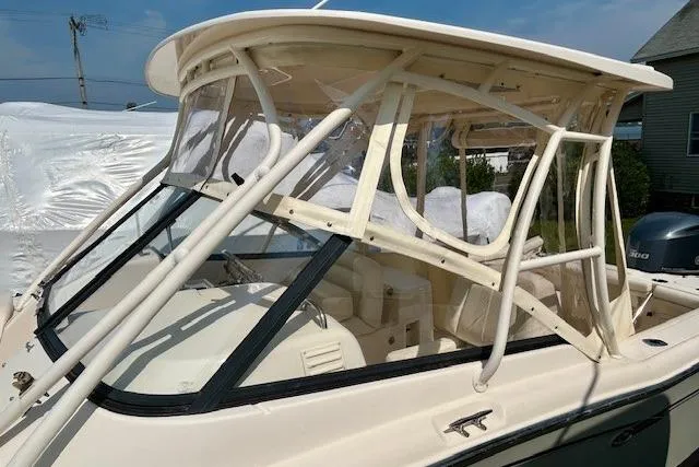 Slide: The Image of 2015 Grady-White Freedom 255 boat with enclosed cockpit and clear windows. - 14