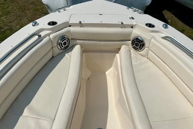 Slide: The Image of 2015 Grady-White Freedom 255 boat interior with cushioned seating and cup holders. - 15