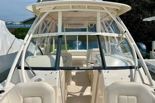 Slide: The Image of 2015 Grady-White Freedom 255 boat interior with seating and clear enclosure. - 16