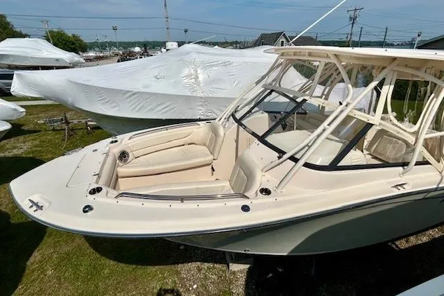 Slide: The Image of 2015 Grady-White Freedom 255 boat with beige seating, docked outdoors. - 17