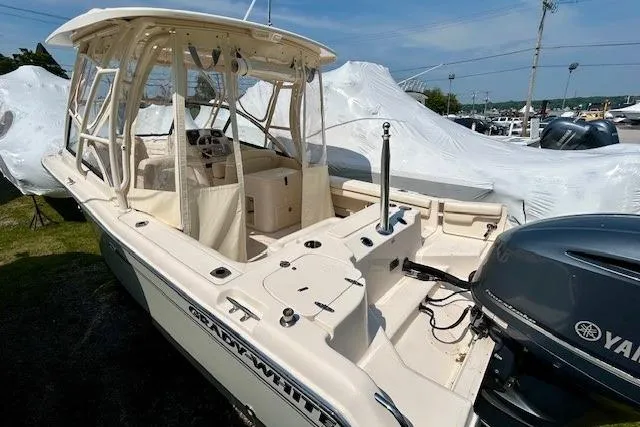 Slide: The Image of 2015 Grady-White Freedom 255 boat with Yamaha engine, docked outdoors. - 19