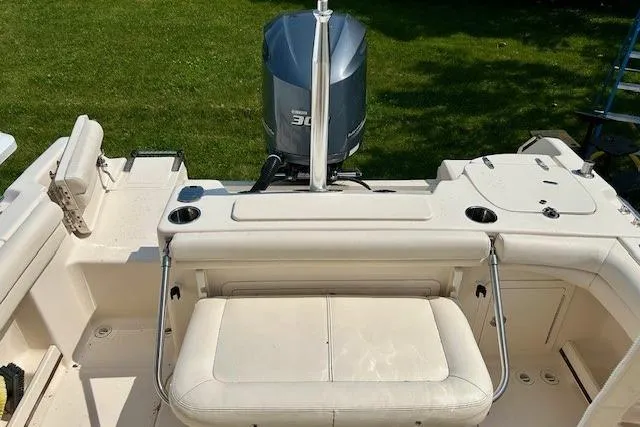 Slide: The Image of 2015 Grady-White Freedom 255 boat interior with seating and outboard motor. - 20
