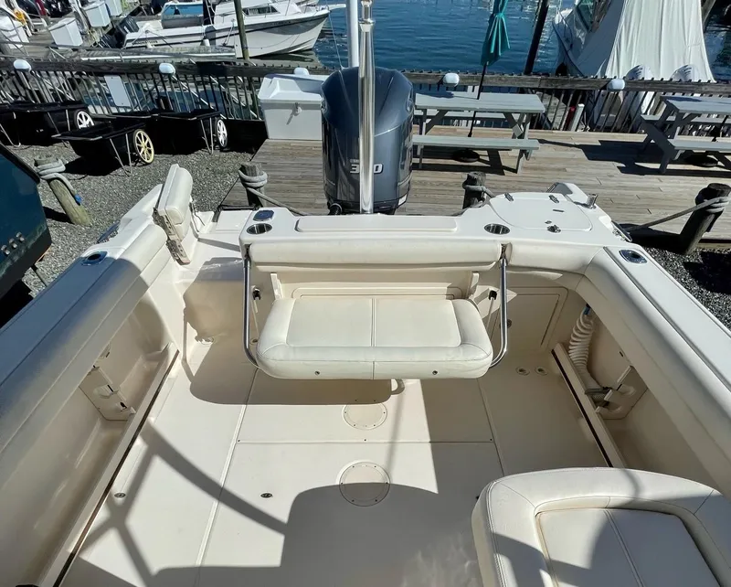 Slide: The Image of 2015 Grady-White Freedom 255 boat interior with seating and engine view. - 21