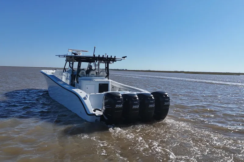 Slide: The Image of 2016 Yellowfin 42 Offshore boat with four powerful outboard engines on open water. - 15