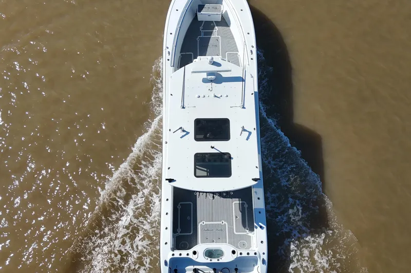 Slide: The Image of Overhead view of 2016 Yellowfin 42 Offshore boat cruising on water. - 16