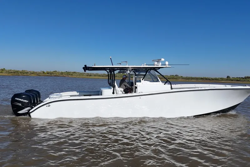 Slide: The Image of 2016 Yellowfin 42 Offshore boat cruising on calm waters under clear blue sky. - 20
