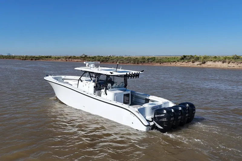Slide: The Image of 2016 Yellowfin 42 Offshore boat cruising on a river with clear blue sky. - 23