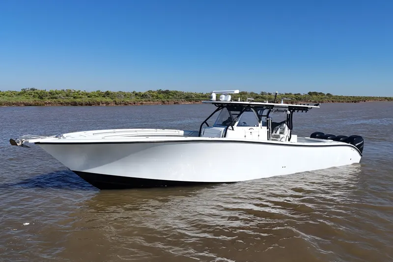 Slide: The Image of 2016 Yellowfin 42 Offshore boat on calm water under clear blue sky. - 27