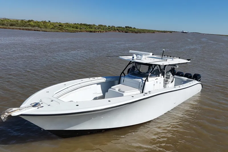 Slide: The Image of 2016 Yellowfin 42 Offshore boat on calm water, featuring sleek design and powerful engines. - 29