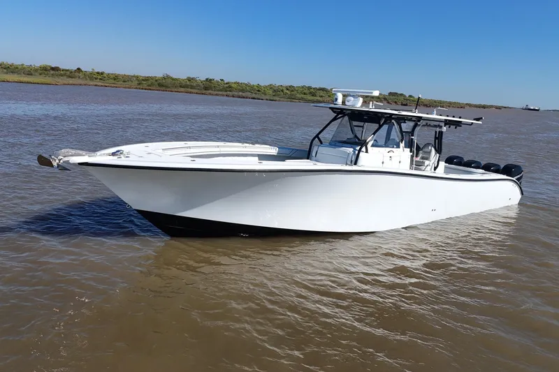 Slide: The Image of 2016 Yellowfin 42 Offshore boat on calm water under clear blue sky. - 30