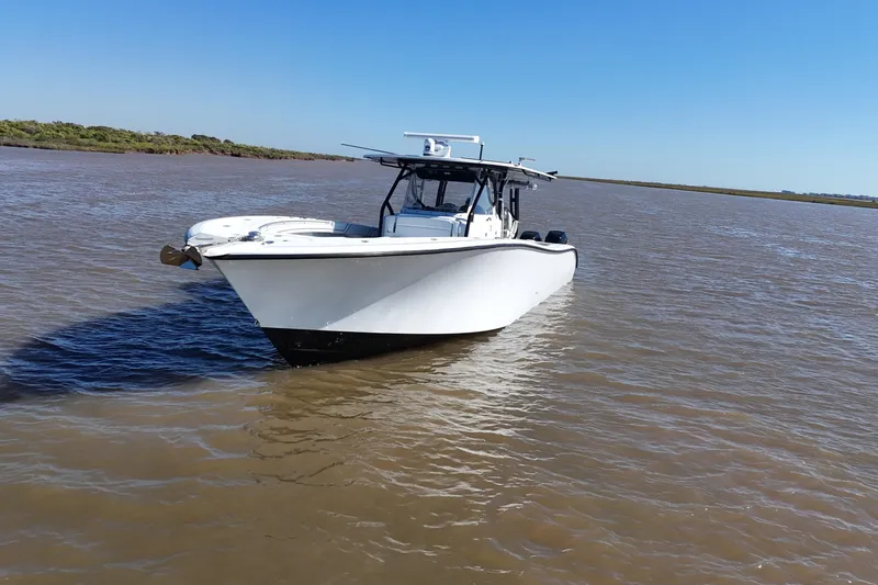 Slide: The Image of 2016 Yellowfin 42 Offshore boat on calm waters under clear blue sky. - 31