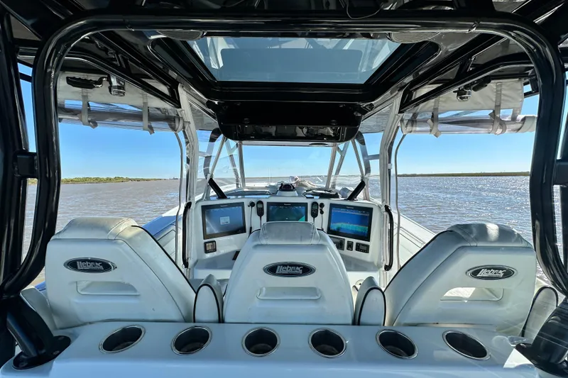 Slide: The Image of 2016 Yellowfin 42 Offshore boat cockpit with advanced navigation systems on open water. - 35