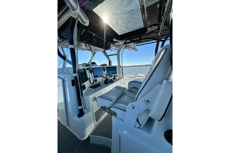 Slide: The Image of 2016 Yellowfin 42 Offshore boat interior with modern controls and seating. - 39