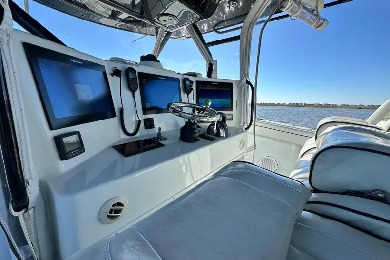 Slide: The Image of 2016 Yellowfin 42 Offshore boat cockpit with advanced navigation systems and luxurious seating. - 40