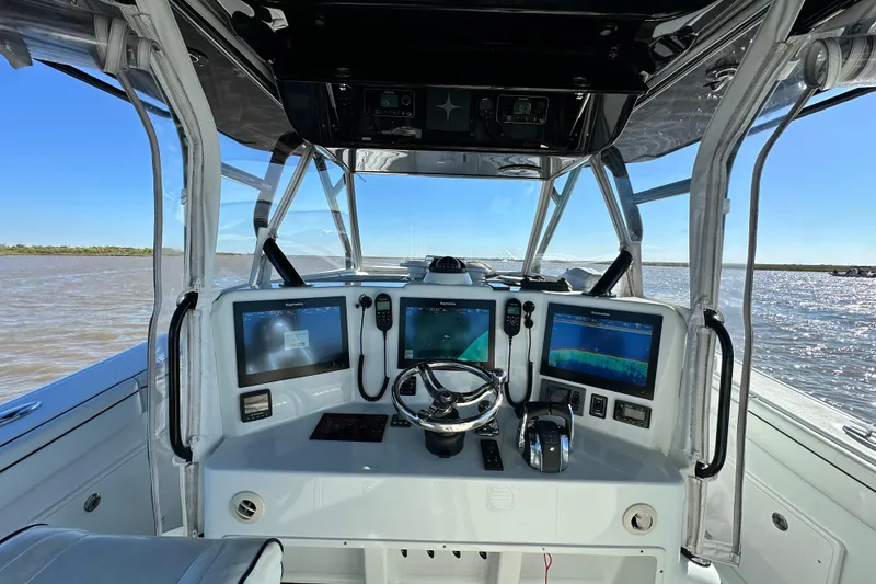 Slide: The Image of 2016 Yellowfin 42 Offshore boat cockpit with advanced navigation displays on open water. - 41