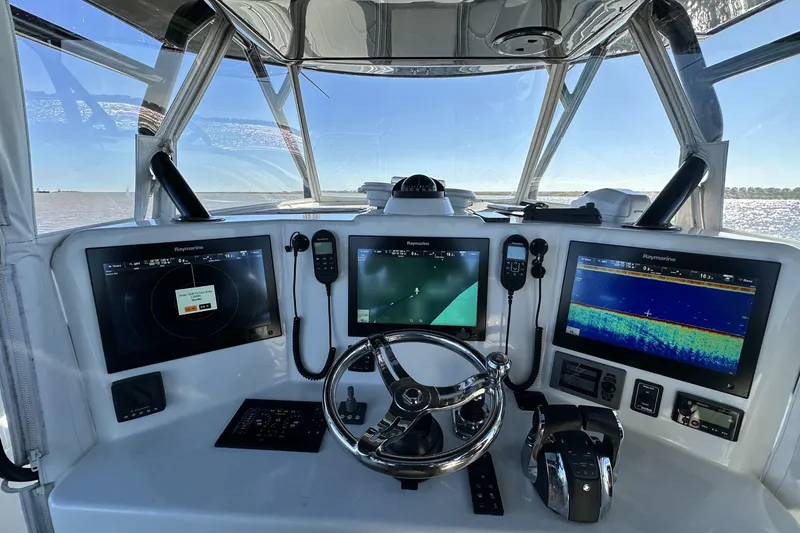 Slide: The Image of 2016 Yellowfin 42 Offshore boat dashboard with advanced navigation and control systems. - 42