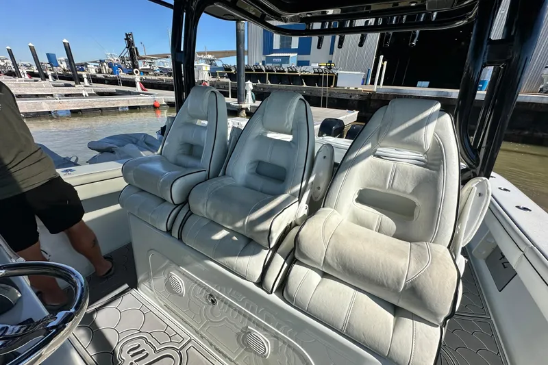 Slide: The Image of 2016 Yellowfin 42 Offshore boat interior with three cushioned seats at the dock. - 45