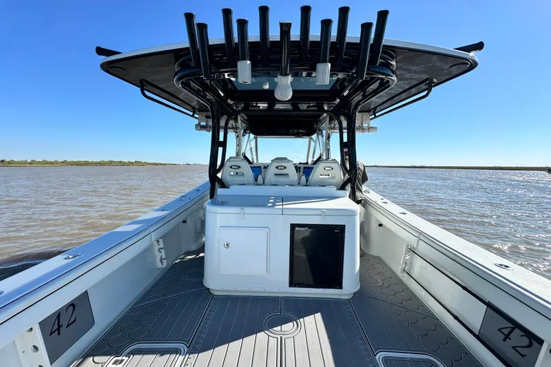Slide: The Image of 2016 Yellowfin 42 Offshore boat interior with rod holders, on calm water. - 50