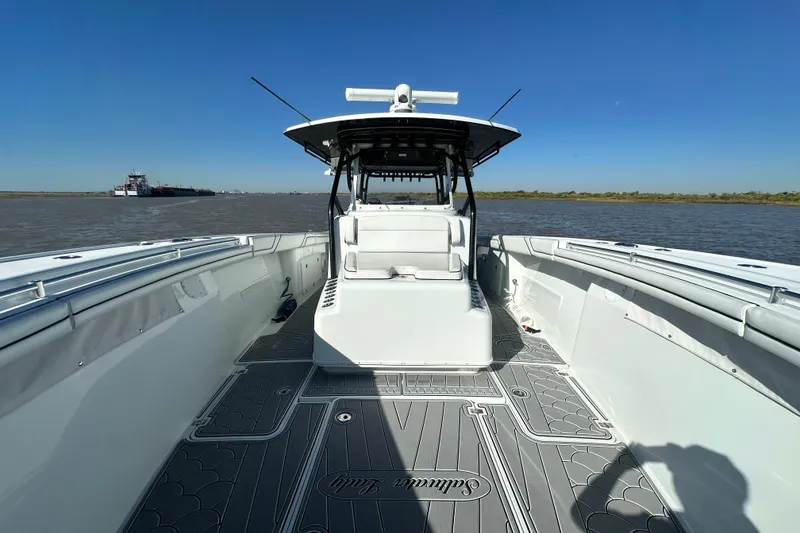 Slide: The Image of 2016 Yellowfin 42 Offshore boat on water, spacious deck, clear sky background. - 52