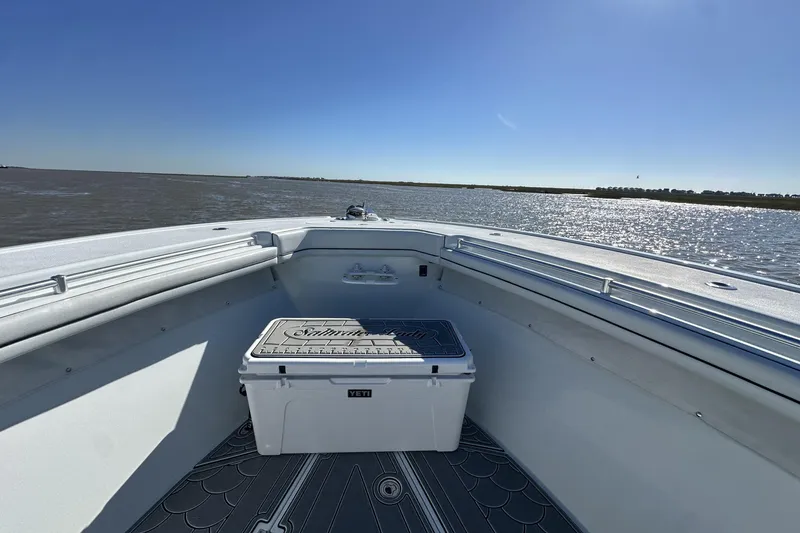 Slide: The Image of 2016 Yellowfin 42 Offshore boat with Yeti cooler on deck, cruising on a sunny day. - 56
