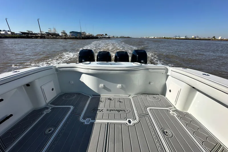 Slide: The Image of 2016 Yellowfin 42 Offshore boat with triple engines cruising on open water. - 58