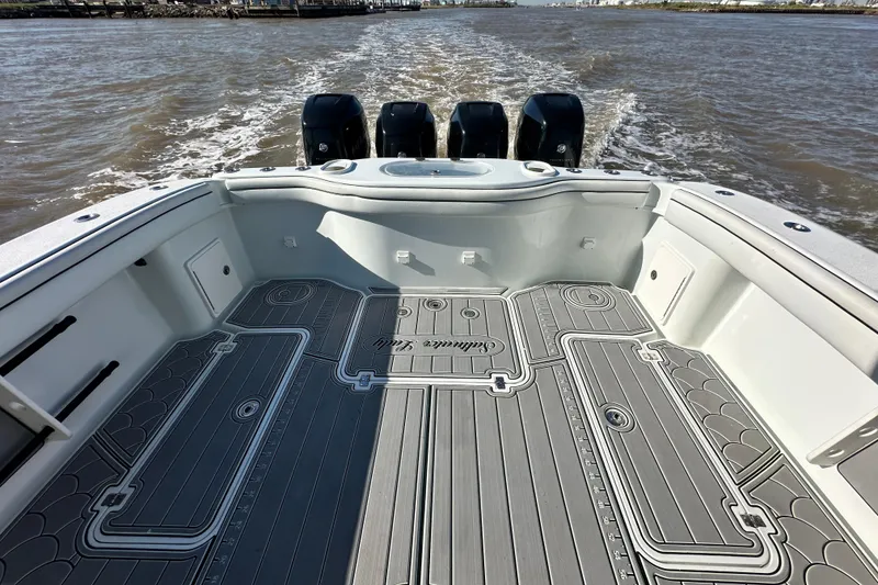 Slide: The Image of 2016 Yellowfin 42 Offshore boat with four outboard motors on open water. - 60