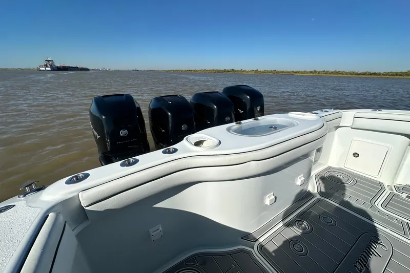 Slide: The Image of 2016 Yellowfin 42 Offshore boat with multiple outboard engines on a calm river. - 61