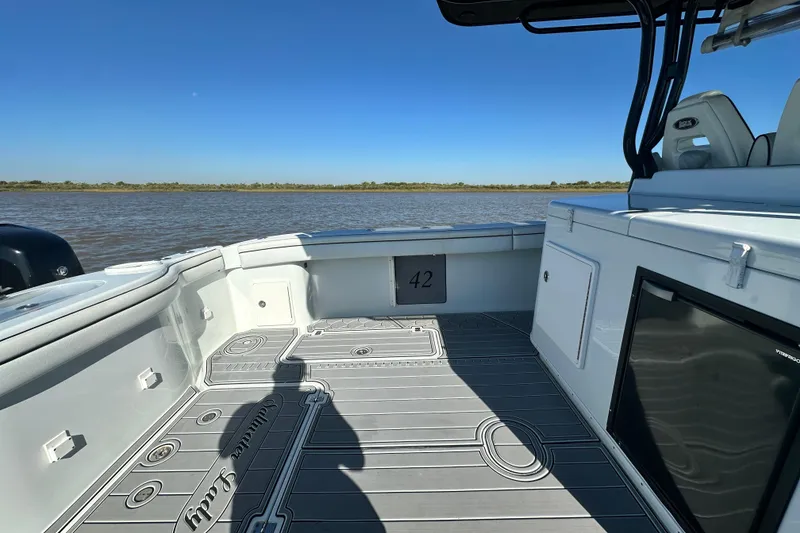 Slide: The Image of 2016 Yellowfin 42 Offshore boat interior with sleek design and open water view. - 62
