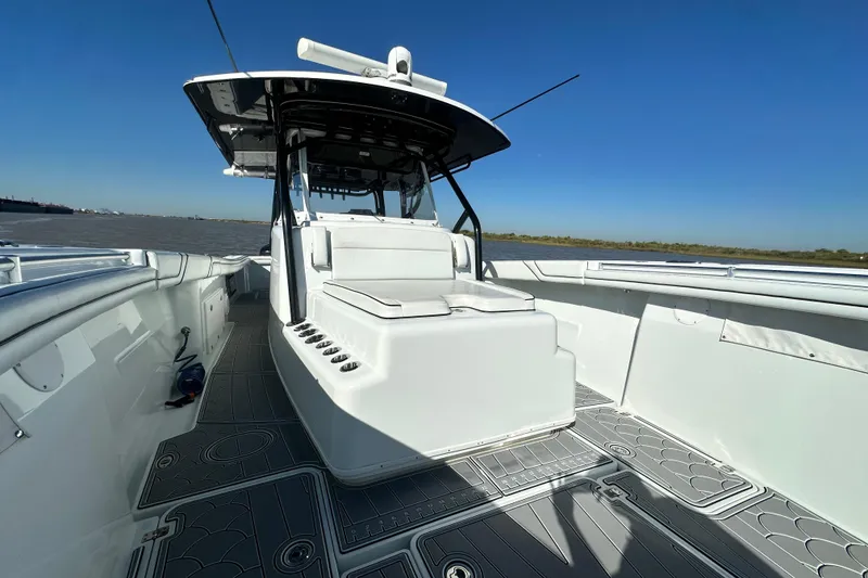 Slide: The Image of 2016 Yellowfin 42 Offshore boat with spacious deck and sleek design on open water. - 65