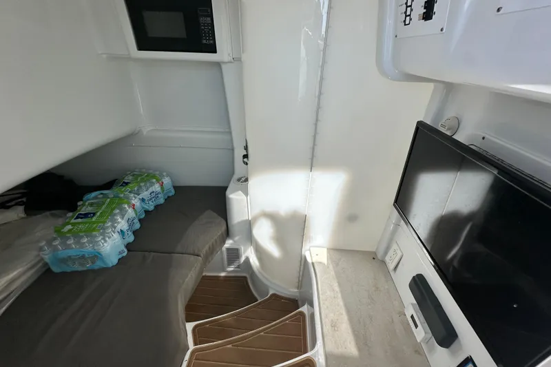 Slide: The Image of Interior of 2016 Yellowfin 42 Offshore boat with TV, microwave, and seating area. - 67