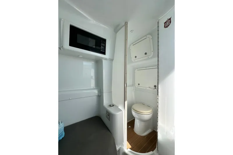 Slide: The Image of 2016 Yellowfin 42 Offshore boat interior with toilet and microwave. - 71