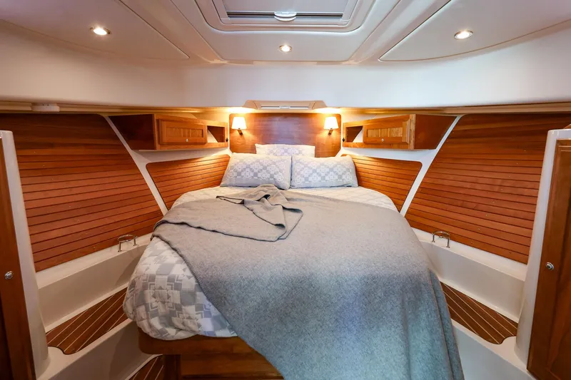 Slide: The Image of Luxurious cabin interior of 2024 Back Cove 39O yacht with cozy bed and wooden accents. - 16
