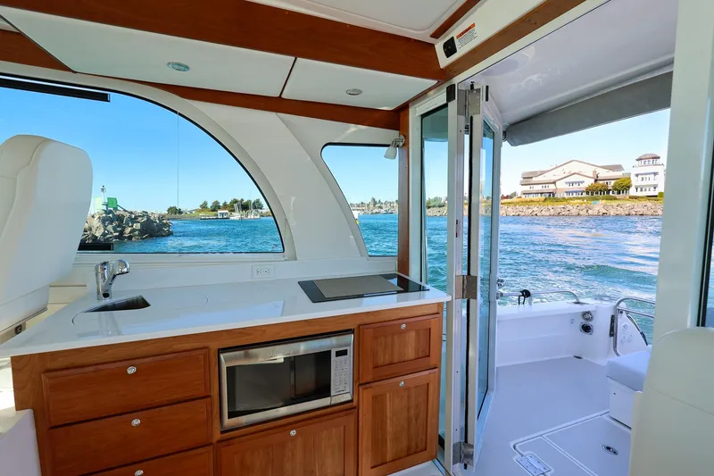 Slide: The Image of 2024 Back Cove 39O Galley with deep sink, cooktop and combo microwave/convection oven. - 26