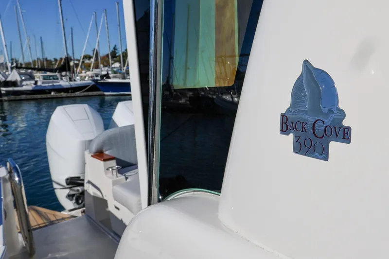 Slide: The Image of 2024 Back Cove 39O boat with logo, docked in marina. - 5