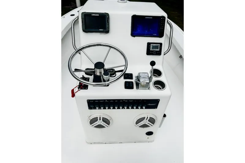 Slide: The Image of 2024 Hanson 23 boat console with steering wheel, navigation screens, and control panel. - 4