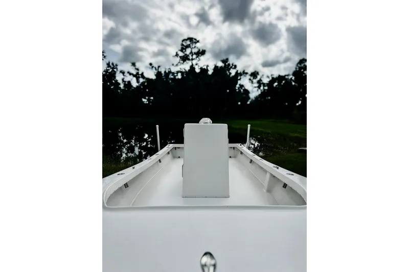 Slide: The Image of 2024 Hanson 23 boat on calm water under cloudy sky. - 8