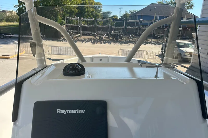 Slide: The Image of 2015 Century 2901 Center Console boat dashboard with Raymarine equipment and compass. - 13