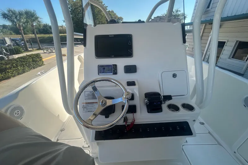 Slide: The Image of 2015 Century 2901 Center Console boat dashboard with steering wheel and navigation equipment. - 16