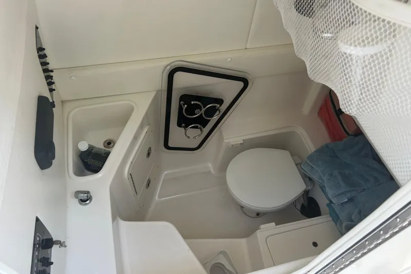 Slide: The Image of Interior of 2015 Century 2901 Center Console boat with toilet and storage area. - 19