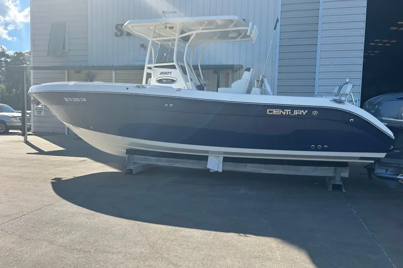 Slide: The Image of 2015 Century 2901 Center Console boat in blue, displayed outdoors on a stand. - 2