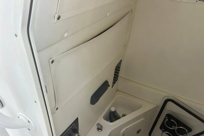 Slide: The Image of Interior of a 2015 Century 2901 Center Console boat, featuring storage and cup holders. - 20