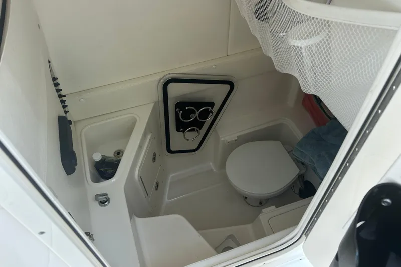 Slide: The Image of 2015 Century 2901 Center Console boat interior with toilet and storage area. - 21