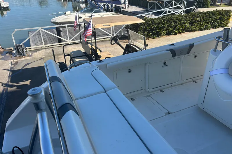 Slide: The Image of 2015 Century 2901 Center Console boat docked, featuring spacious seating and storage. - 34