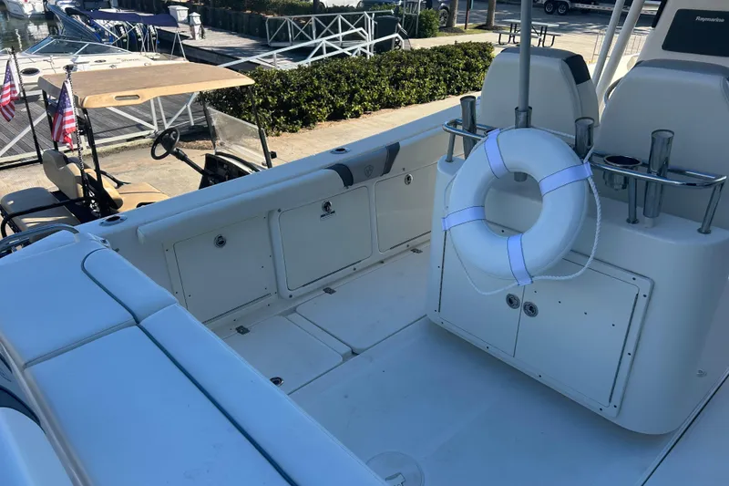 Slide: The Image of 2015 Century 2901 Center Console boat interior with life preserver and dock view. - 35